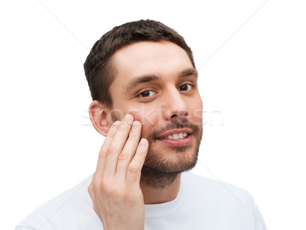 Hermosa sonriendo hombre tocar cara salud Foto stock © dolgachov