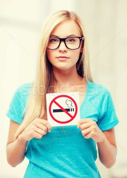 woman with smoking restriction sign Stock photo © dolgachov