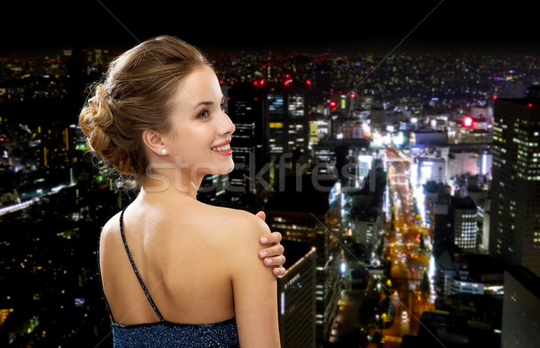 Uśmiechnięta kobieta suknia wieczorowa ludzi wakacje glamour czarny Zdjęcia stock © dolgachov