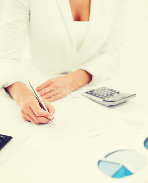 businesswoman working with calculator in office Stock photo © dolgachov