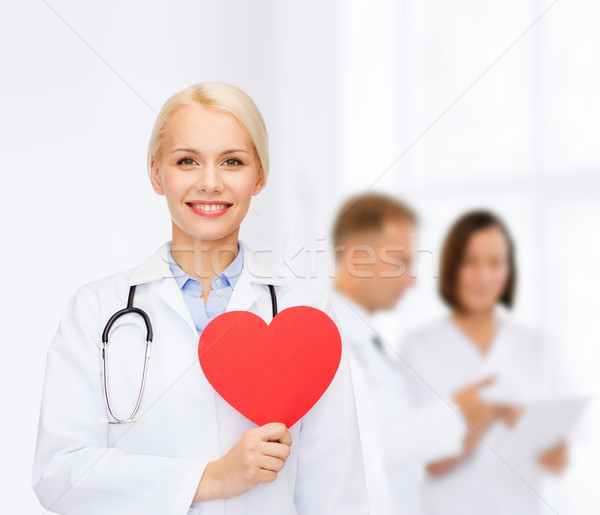Sorridere femminile medico cuore stetoscopio sanitaria Foto d'archivio © dolgachov