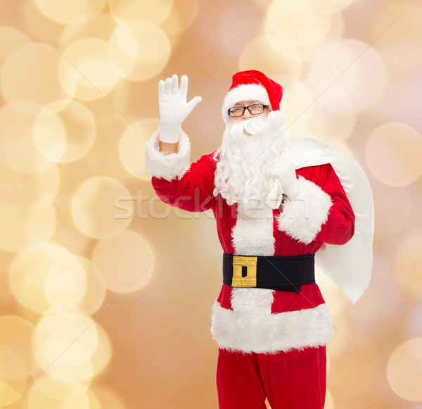 man in costume of santa claus with bag Stock photo © dolgachov