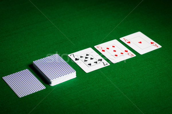 playing cards on green table surface Stock photo © dolgachov
