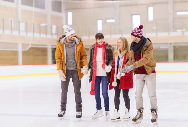 Stock photo: happy friends on skating rink