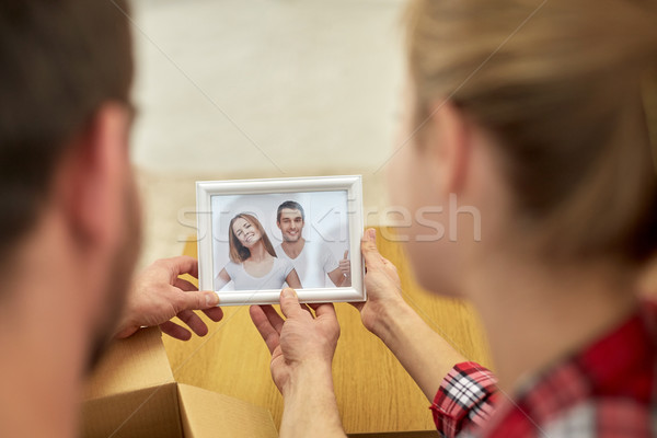 close up of happy couple looking at family photo Stock photo © dolgachov
