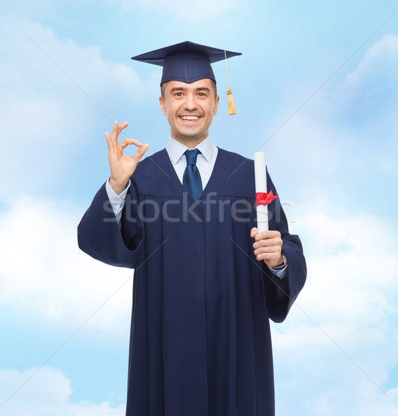 smiling adult student in mortarboard with diploma Stock photo © dolgachov