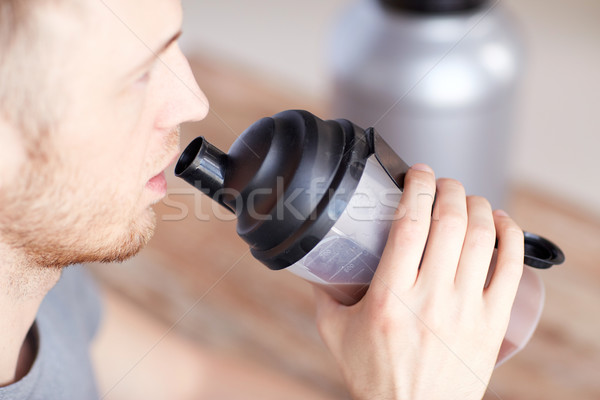 Stock photo: close up of man drinking protein shake