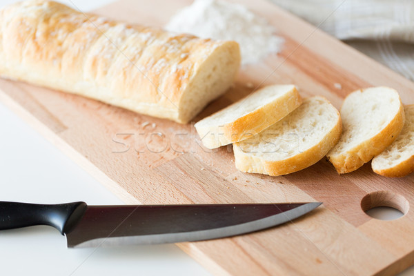 close up of white bread or baguette and knife Stock photo © dolgachov