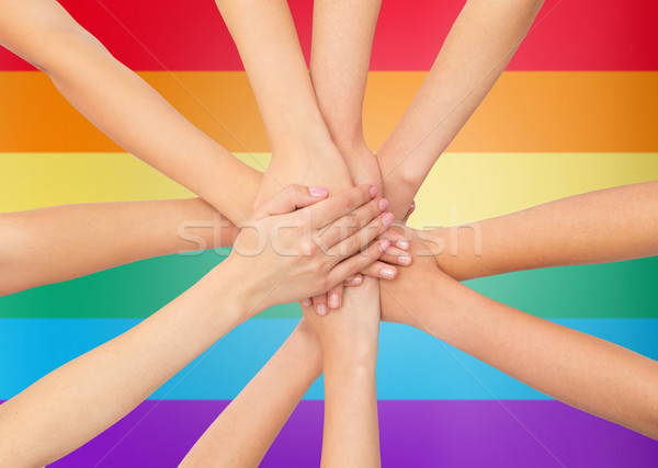 close up of women with hands on top over rainbow Stock photo © dolgachov