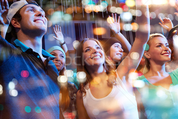 Stock photo: group of happy friends at concert in night club