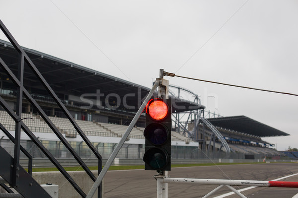 red traffic lights and road sign on race track Stock photo © dolgachov
