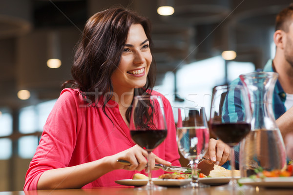 happy woman having dinner at restaurant Stock photo © dolgachov