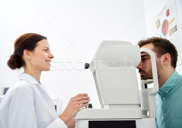 optician with tonometer and patient at eye clinic Stock photo © dolgachov