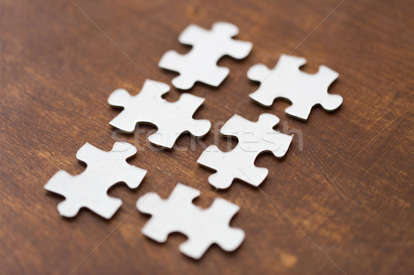 close up of puzzle pieces on wooden surface Stock photo © dolgachov