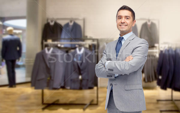 happy businessman in suit over clothing store Stock photo © dolgachov