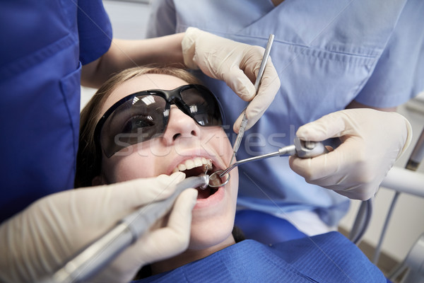 female dentists treating patient girl teeth Stock photo © dolgachov