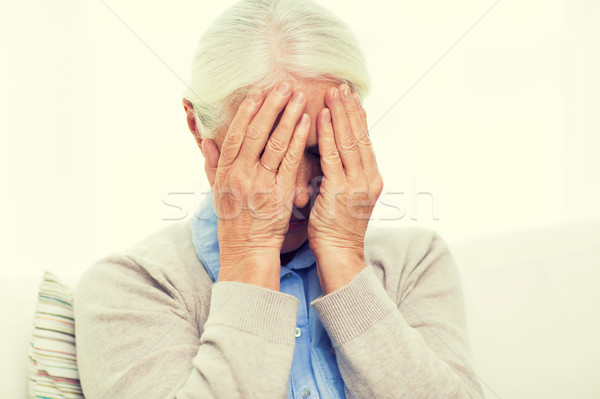 Stock photo: senior woman suffering from headache or grief