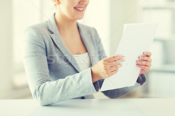 close up of woman reading papers or tax report Stock photo © dolgachov