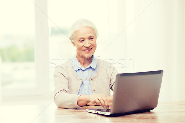 happy senior woman with laptop at home Stock photo © dolgachov