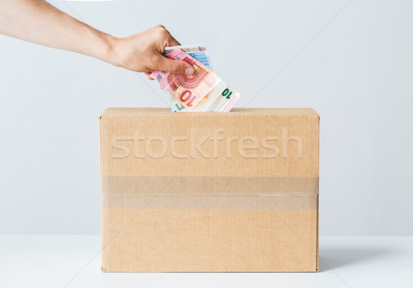 Férfi Euro pénz adomány doboz jótékonyság Stock fotó © dolgachov