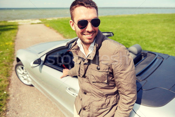 happy man near cabriolet car outdoors Stock photo © dolgachov