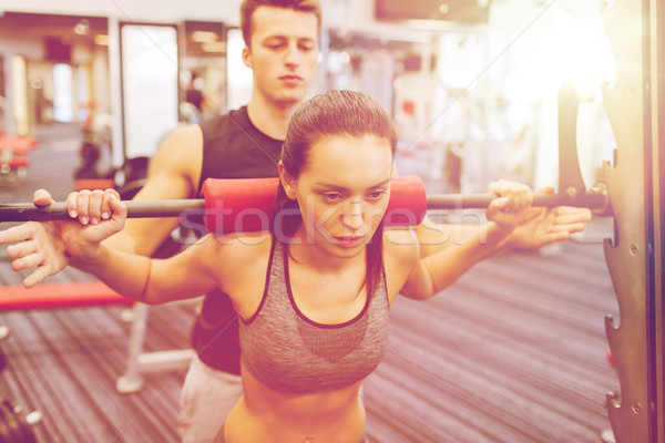 Hombre mujer barra con pesas músculos gimnasio deporte Foto stock © dolgachov