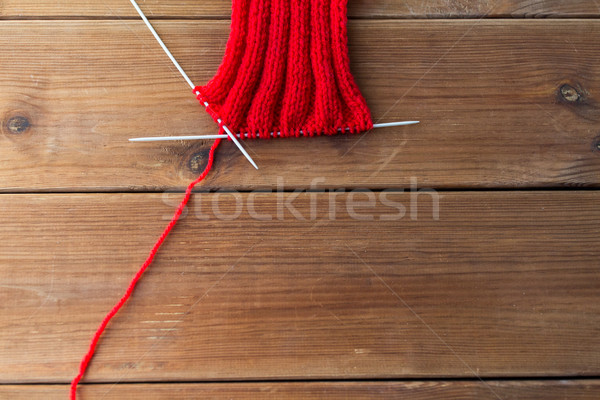 hand-knitted item with knitting needles on wood Stock photo © dolgachov