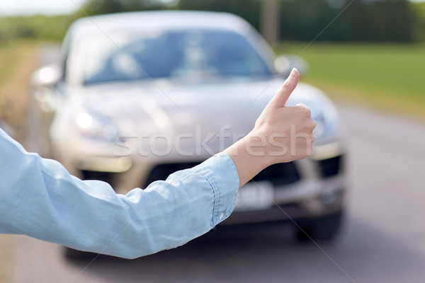 woman hitchhiking and stopping car with thumbs up Stock photo © dolgachov