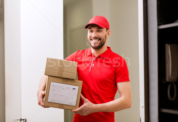 delivery man with parcel boxes at customer door Stock photo © dolgachov