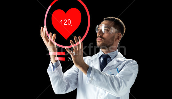 doctor or scientist with heart rate projection Stock photo © dolgachov