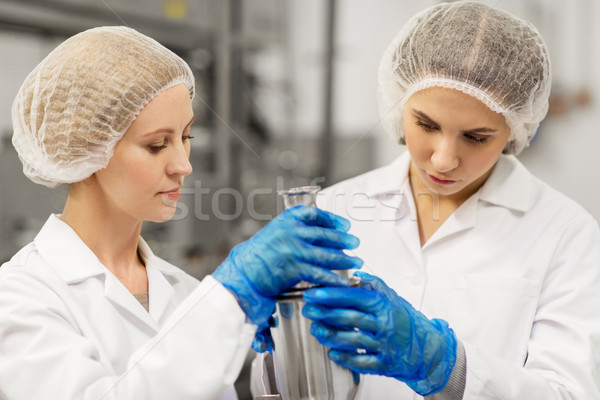 women technologists working at ice cream factory Stock photo © dolgachov