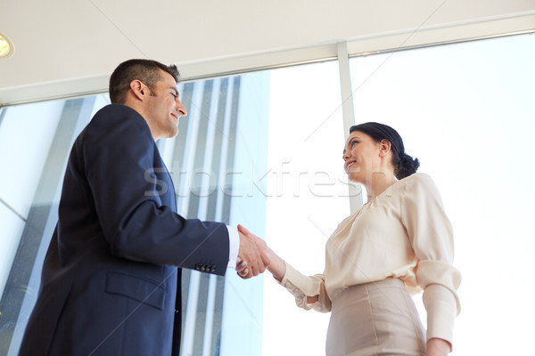 smiling business people shaking hands at office Stock photo © dolgachov