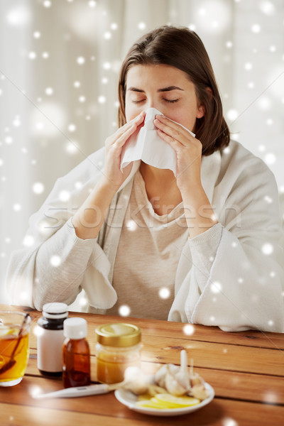 sick woman with medicine blowing nose to wipe Stock photo © dolgachov