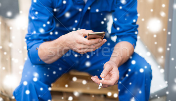 auto mechanic smoking cigarette at car workshop Stock photo © dolgachov