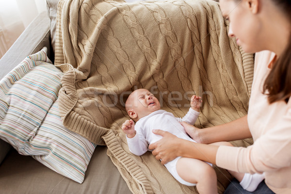 mother soothing crying little baby boy at home Stock photo © dolgachov
