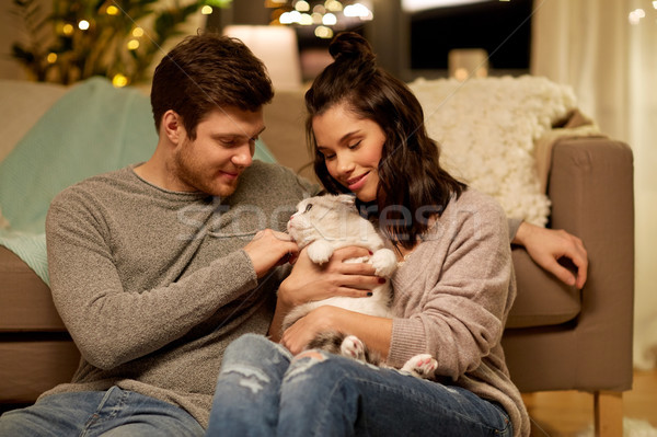 happy couple with cat at home Stock photo © dolgachov
