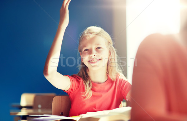 happy student girl raising hand at school lesson Stock photo © dolgachov