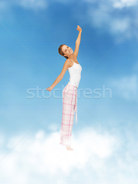 woman in pajamas doing morning exercise Stock photo © dolgachov