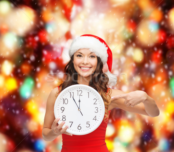 woman in santa helper hat with clock showing 12 Stock photo © dolgachov