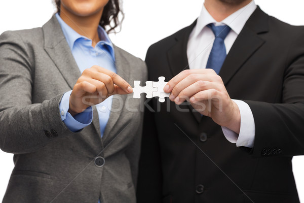 Stock photo: businessman and businesswoman with puzzle pieces