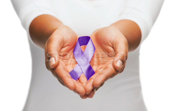 hands holding purple awareness ribbon Stock photo © dolgachov