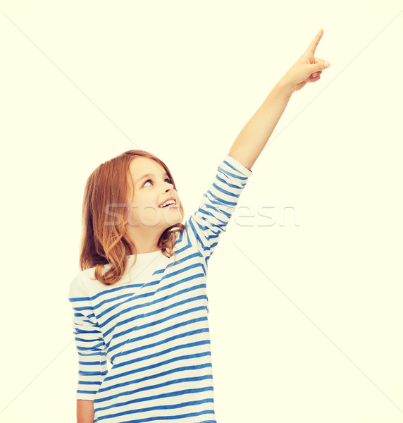 smiling girl pointing at virtual screen Stock photo © dolgachov