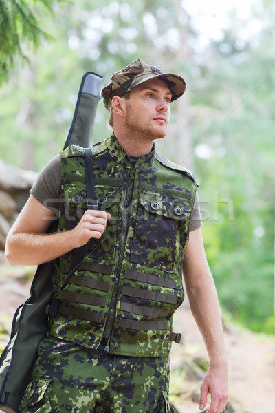 young soldier or hunter with gun in forest Stock photo © dolgachov