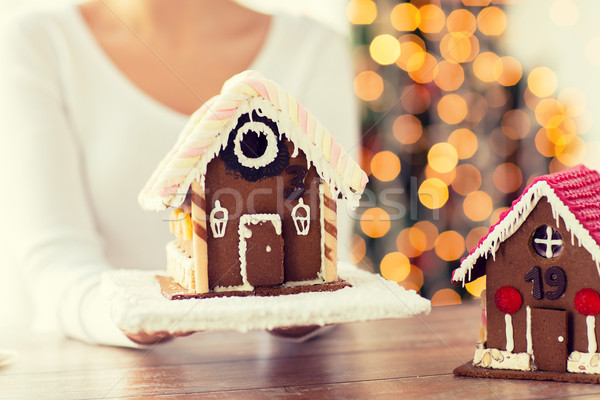 close up of woman showing gingerbread house Stock photo © dolgachov