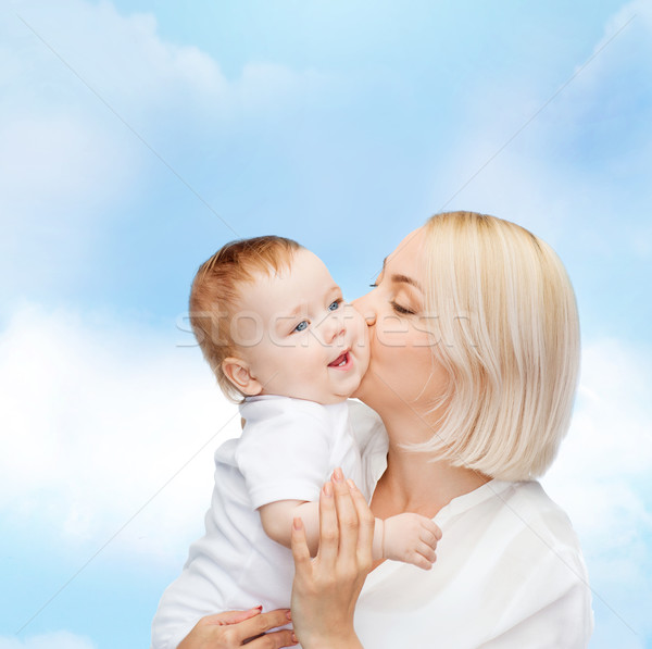 Stock photo: happy mother kissing smiling baby