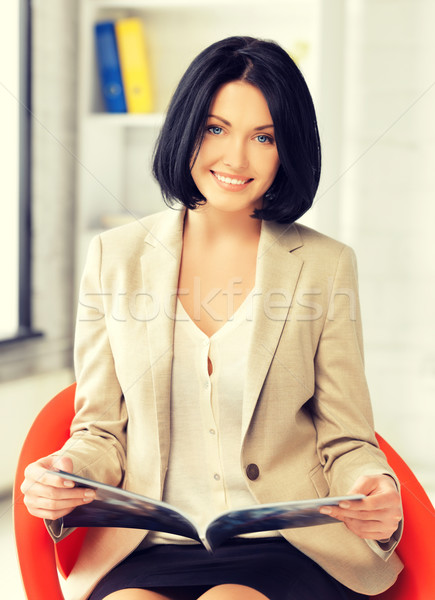 Stock photo: businesswoman with magazine