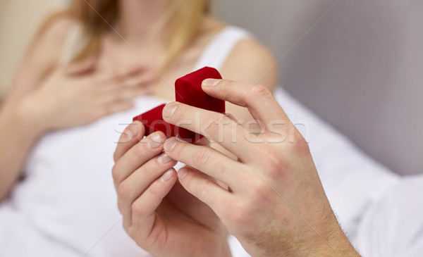 close up of hands holding little red gift box Stock photo © dolgachov