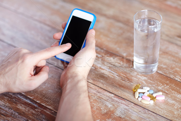 Mâini smartphone pastile apă medicină Imagine de stoc © dolgachov