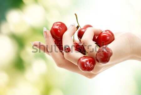 woman mouth with lips and tongue eating cherry Stock photo © dolgachov