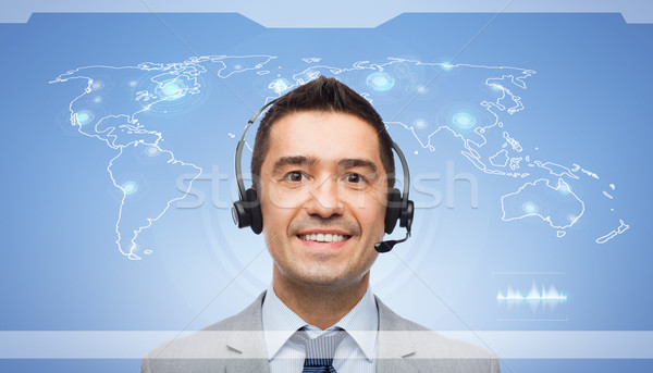 smiling businessman in headset over world map Stock photo © dolgachov